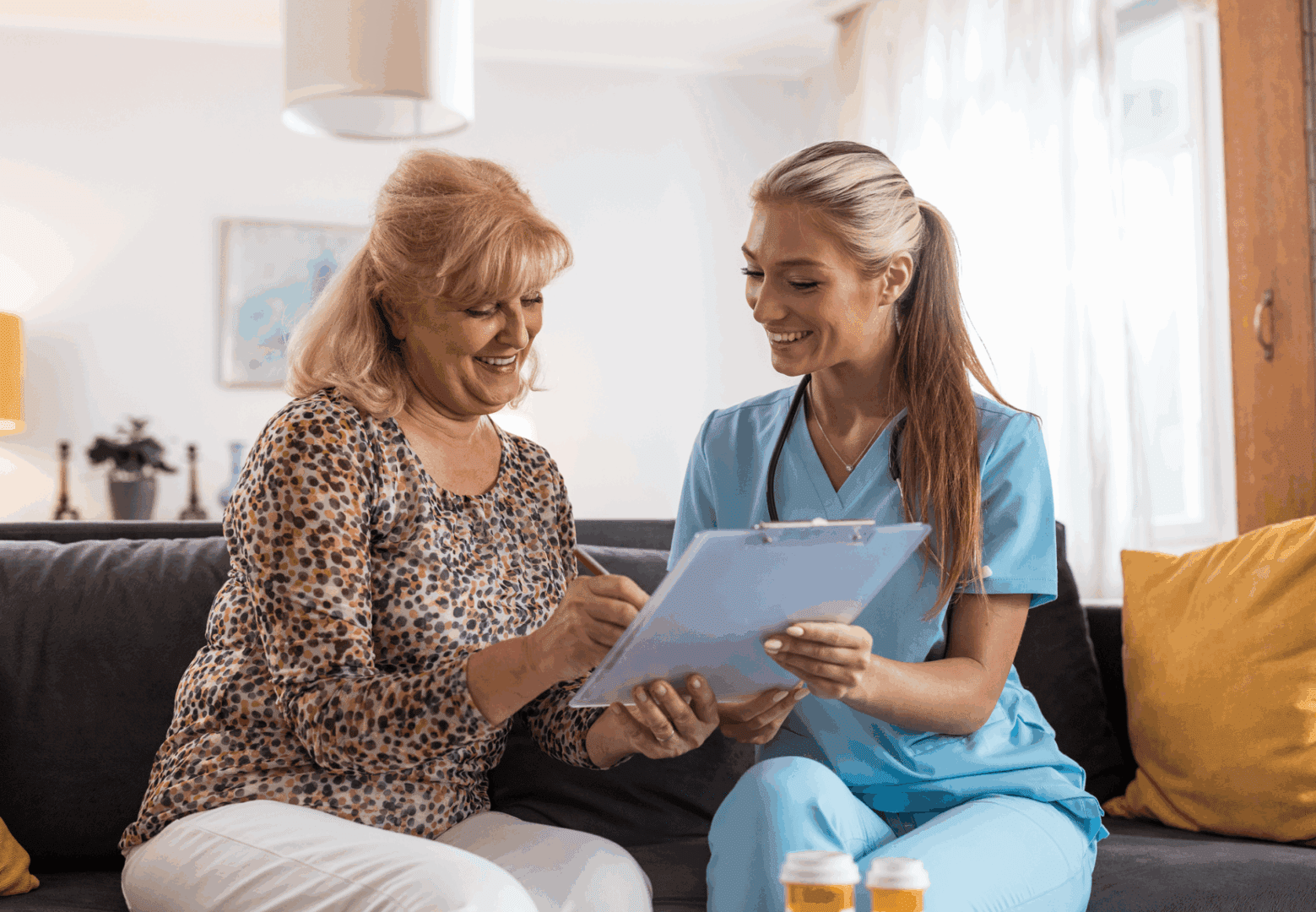 Elderly woman consulting with nurse at home